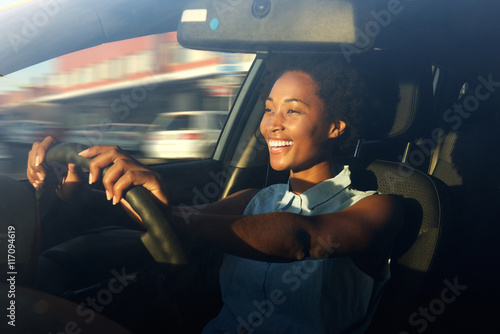 Young african american woman driving a car Poster Mural XXL