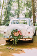 Bumper of retro car with just married sign and cans attached