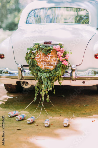 Fotografie, Obraz Vintage wedding car with just married sign and cans attached, close-up