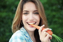 Beautiful Girl Eating Carrot, Closeup