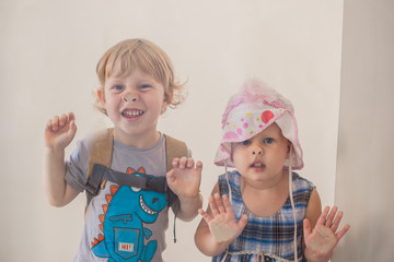 Toddlers Boy and girl pressed his nose to the glass