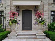 Front Door Of Stone House With Large Flower Pots