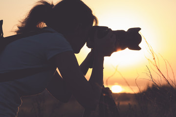 Vintage portrait of a young girl photographer working in the field of professional photographic equipment