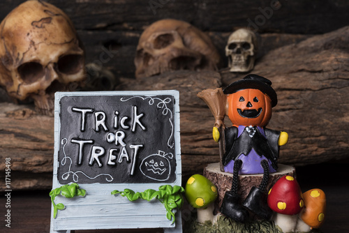 halloween pumkin head Jack-o-lantern in witch suit sitting on a tree over fou...