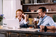 © zinkevych - Couple looking at laptop while having breakfast