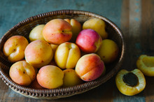 Fresh Apricots In The Basket On A Wooden Table In Rustic Style