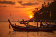 Thai fishing boats during sunset at Kata beach, Phuket, Thailand