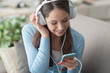 © stokkete - Girl listening to music with her smartphone