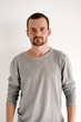 © danilkorolev - Bearded handsome man in grey pullover looking at camera