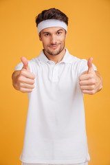 Sticker - Confident young man athlete showing thumbs up with both hands