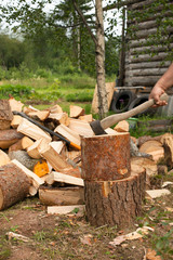 Man is chopping wood with axe