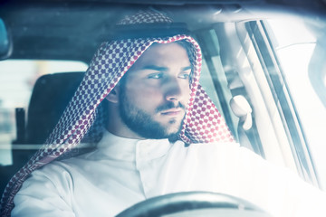 Wall Mural - Portrait of a handsome arabian man driving a car