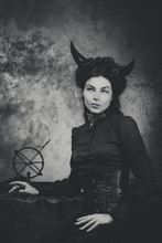 Black And White Retro Photo, Woman Demon, Devil. Girl With Horns, Effect Of Toning