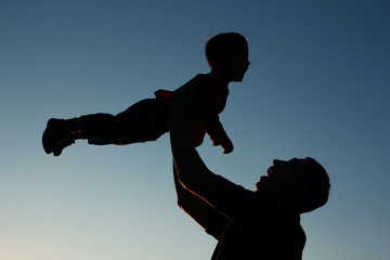 silhouette of father and son