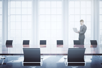 Wall Mural - Man using laptop in conference room