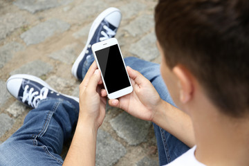 Sticker - Young man with gadget on block stones background