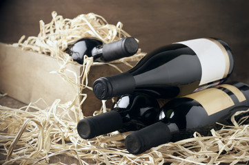 Poster - Wine bottles in wooden box and straw