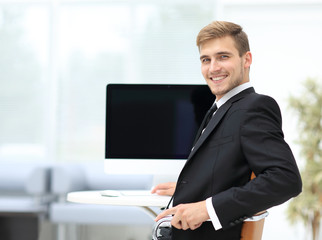 Image of businessman working in office in front  his laptop co