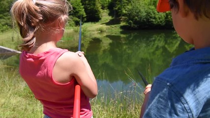 Wall Mural - Kids fishing by mountain lake in summer