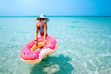 Woman With Inflatable Ring On Beach