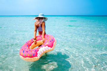 Woman with inflatable ring on beach