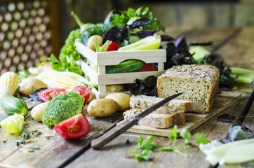 Rye bread with vegetables and spices on a wooden table