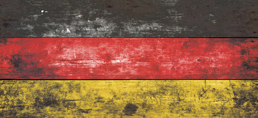 German flag painted on old wood plank background.