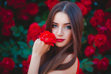 Beautiful Portrait Of Sensual Brunette Young Woman Close To Red Roses