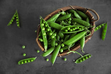 Fresh Peas In Basket On Grey Background