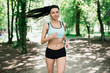 © anatoliycherkas - Beautiful sports girl runs in park
