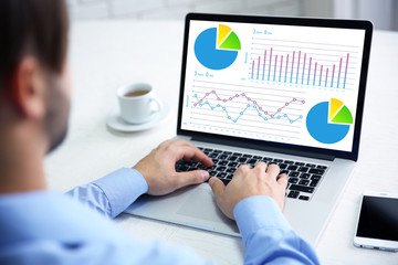 Poster - Young businessman using his laptop, close up