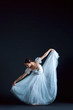 © master1305 - Portrait of the classical ballerina in white dress on black background