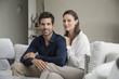 © onoky - Portrait of a happy couple sitting on a couch