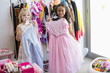 © onoky - Two little girls trying on clothes
