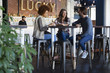 © onoky - Friends talking at cafe table