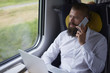 Young businessman talking by mobile phone in the train
