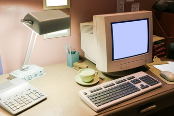 Retro office desk in dark room with simulator object.