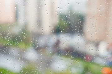 Wall Mural - raindrops on window and blurred houses