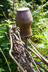 Canvas Print - wattle fence with old clay pot