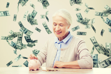 Poster - senior woman putting money to piggy bank at home