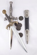 Military daggers and coins on white background