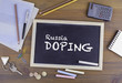 © STOATPHOTO - Russia Doping. Chalkboard on wooden office desk