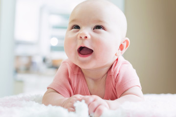 Wall Mural - Happy newborn baby girl smiling