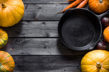 Mix of pumpkins and vegetable on wooden table.