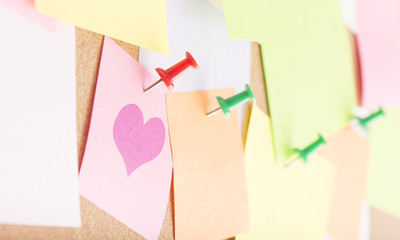 Heart symbol on notice board in office. Concept image of business love, romance and flirting.