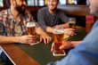 © Syda Productions - happy male friends drinking beer at bar or pub