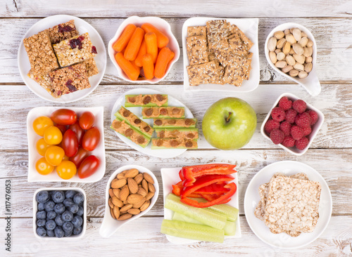 Fotomural Healthy snacks on wooden table, top view