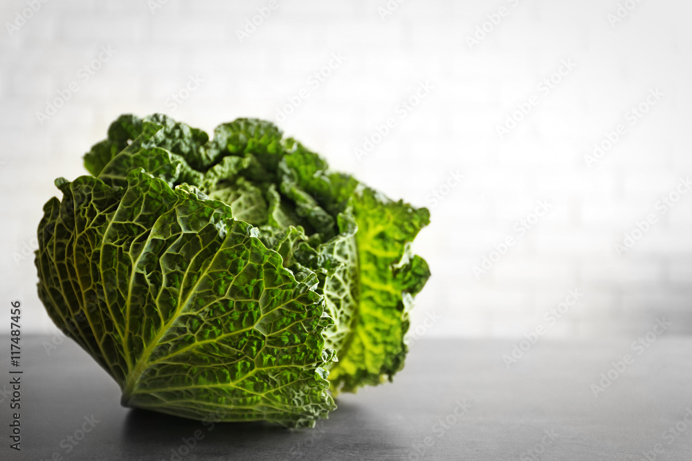 Fresh savoy cabbage on brick wall background