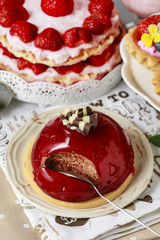 Canvas Print - Chocolate cake with red fruit icing. Party table, various cakes