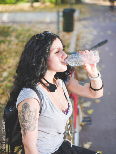 Young Mixed Race Curly Black Hair Woman Relaxing Sitting Outdoor